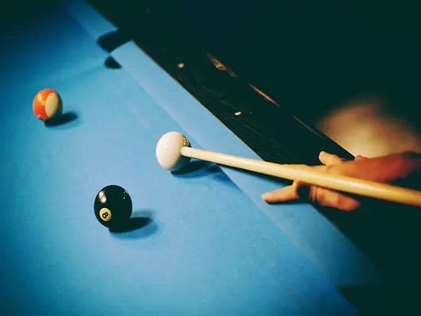 About to hit the cue ball with a cue stick